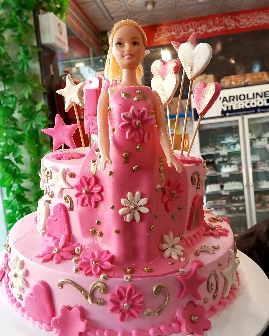 Pink doll cake with a doll on top