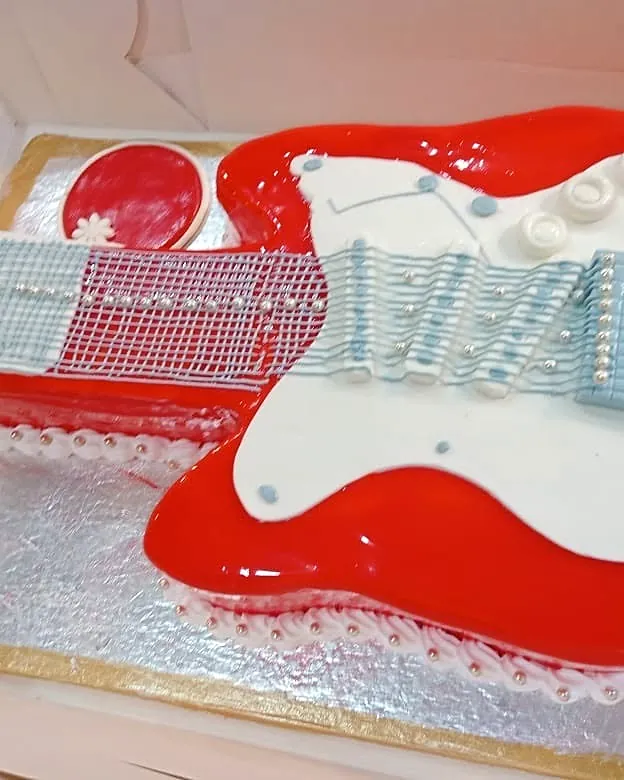 Red and white guitar-shaped cake