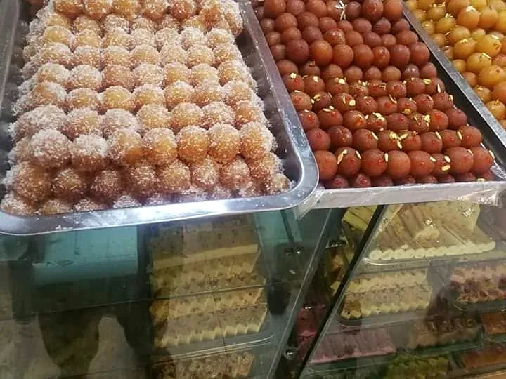 Trays of laddu and gulab jamun at the Freshco counter