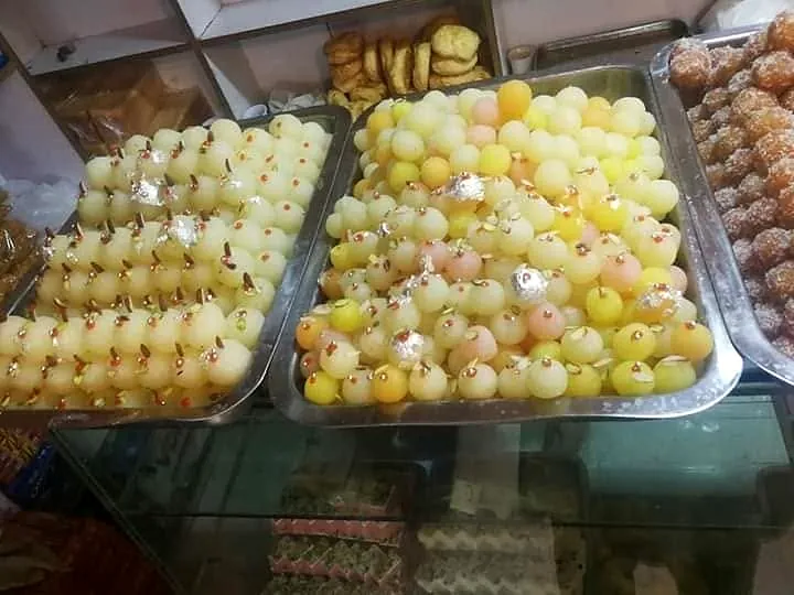 Trays of white and yellow mithai at the counter